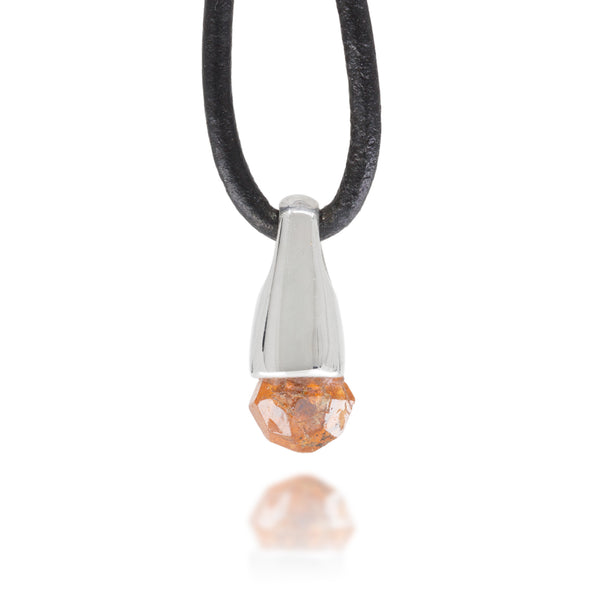 Front view of necklace with a silver and garnet crystal pendant on a black cord against a white background