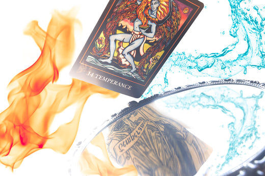 Two versions of the tarot card Temperance, one reflected in a mirror, with flames on the left and water on the right. Photo: ©2025 Tristan Caron