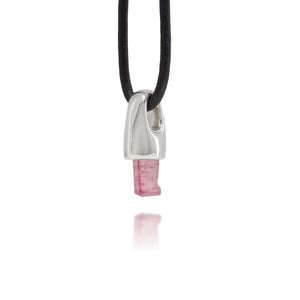 Necklace with a sterling silver and natural pink tourmaline crystal pendant on a black cord against a white background