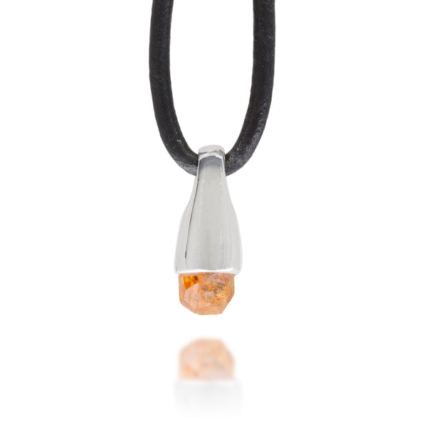 Front view of a necklace with a silver pendant featuring an orange stone on a white background